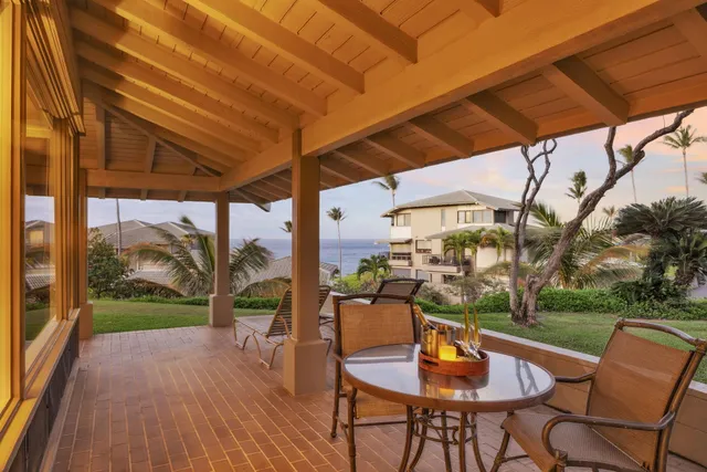 a balcony with table and chairs