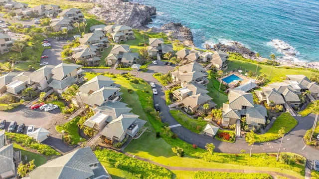 an aerial view of a house with a garden and lake view
