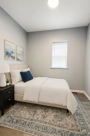 a bedroom with a bed and a window