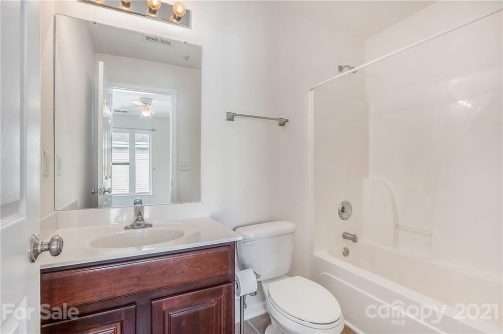 642 Raphael Place Charlotte, NC 28205 - Photo 15 of 27 a bathroom with a sink toilet a mirror and shower