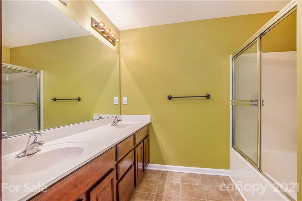 642 Raphael Place Charlotte, NC 28205 - Photo 16 of 27 a bathroom with a sink and a mirror