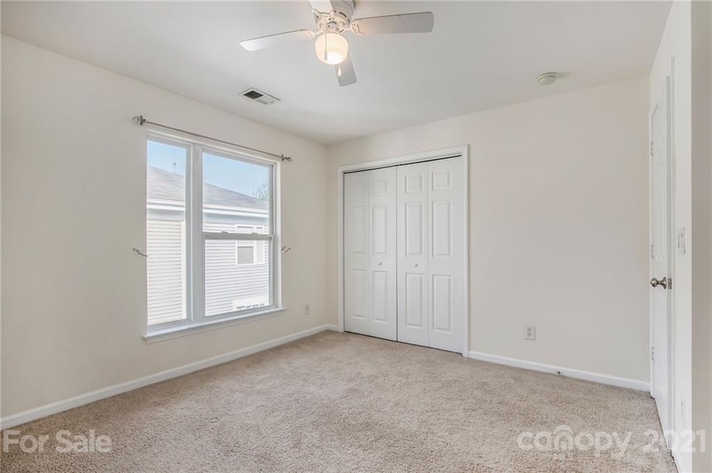 642 Raphael Place Charlotte, NC 28205 - Photo 22 of 27 an empty room with windows and fan