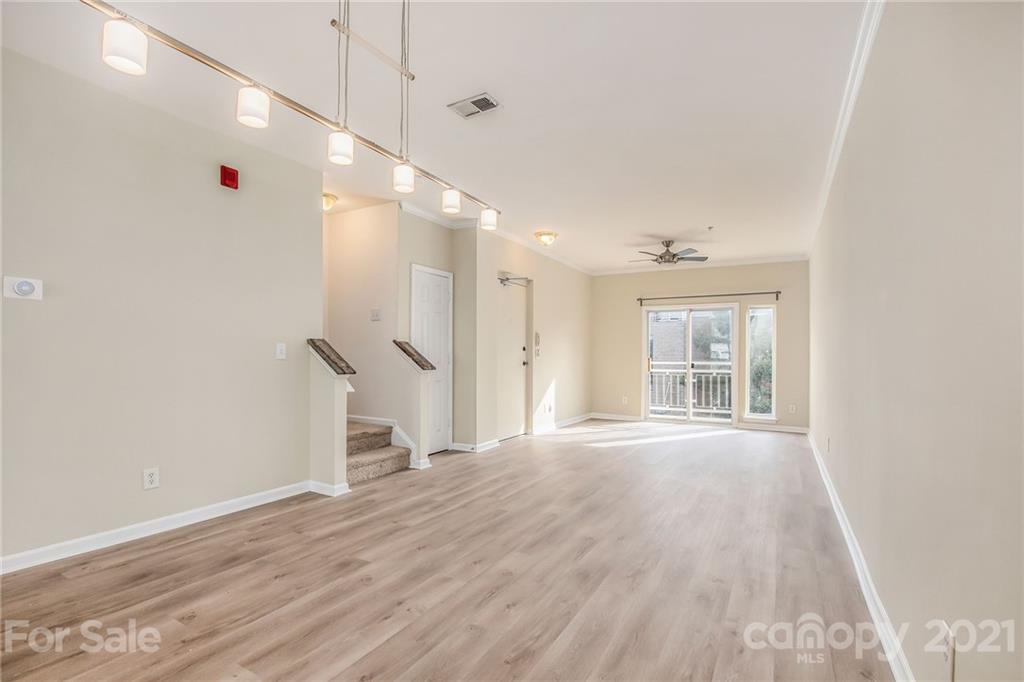 642 Raphael Place Charlotte, NC 28205 - Photo 6 of 27 a view of an empty room with wooden floor and a window