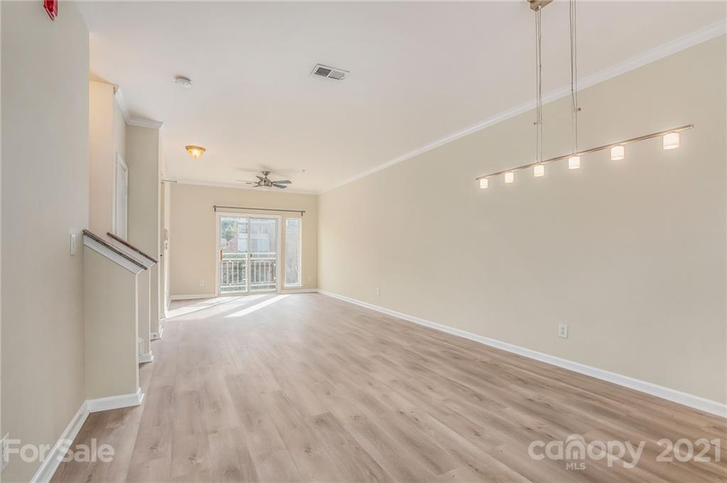 642 Raphael Place Charlotte, NC 28205 - Photo 7 of 27 a view of an empty room with wooden floor and a window