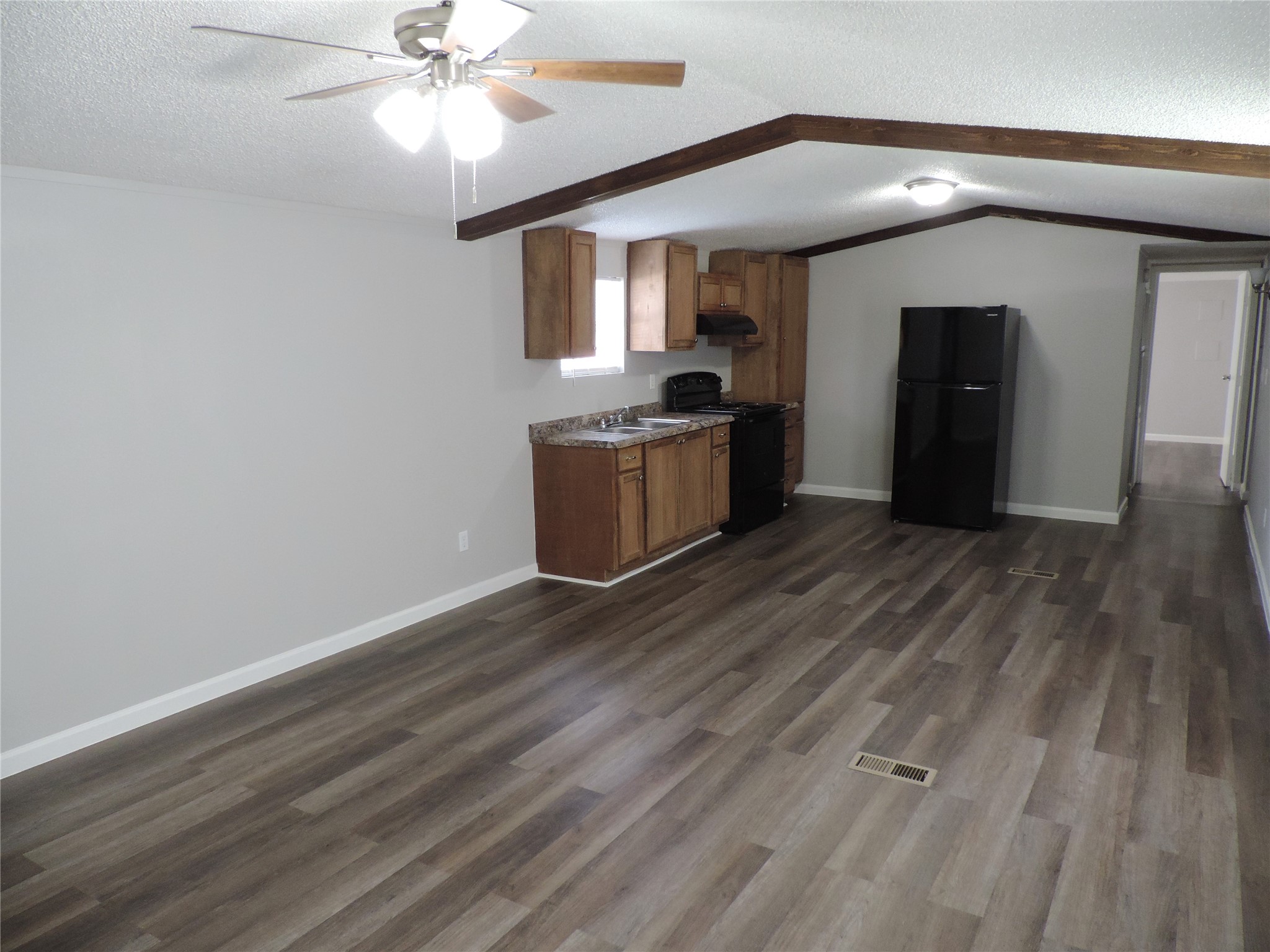 1668 Fm 2518, Unit 85 Cleveland, TX 77327 - Photo 3 of 8 a kitchen with a refrigerator and a stove