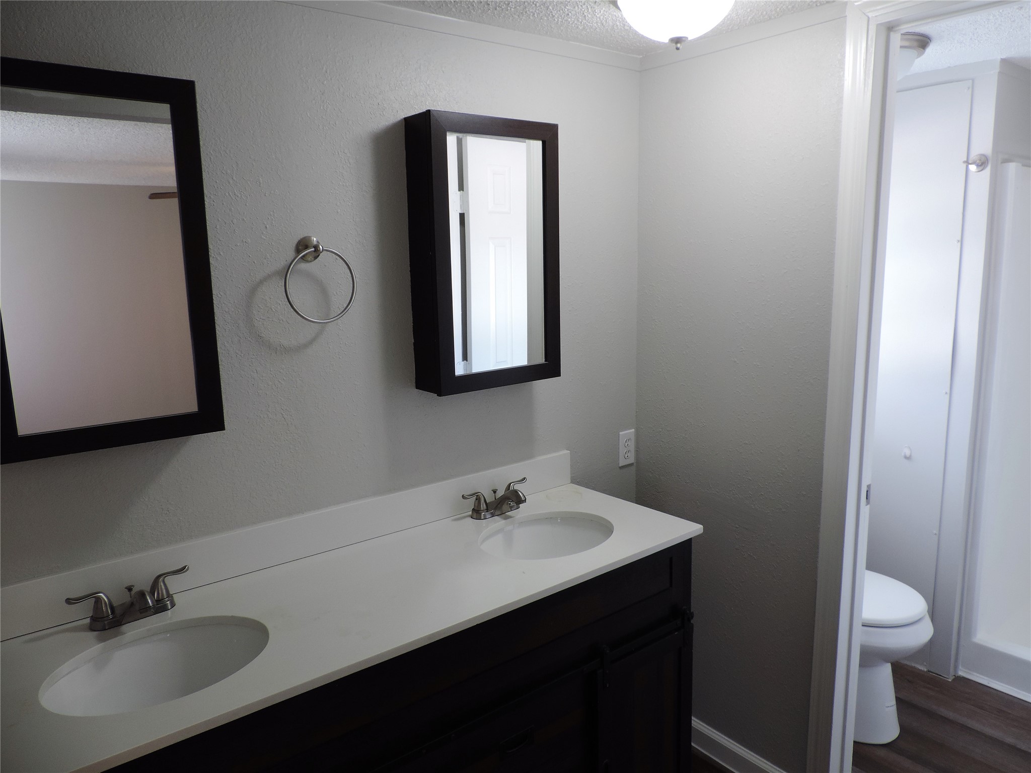 1668 Fm 2518, Unit 85 Cleveland, TX 77327 - Photo 5 of 8 a bathroom with a toilet sink and mirror