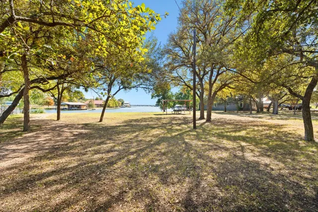 a view of a swimming pool with an outdoor seating and a lake view