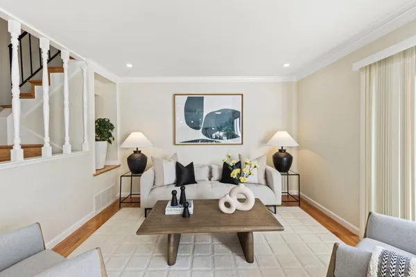 a living room with furniture and wooden floor