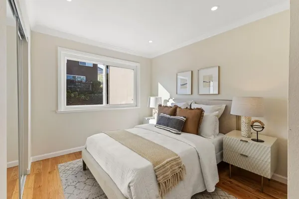 a bedroom with bed and a window