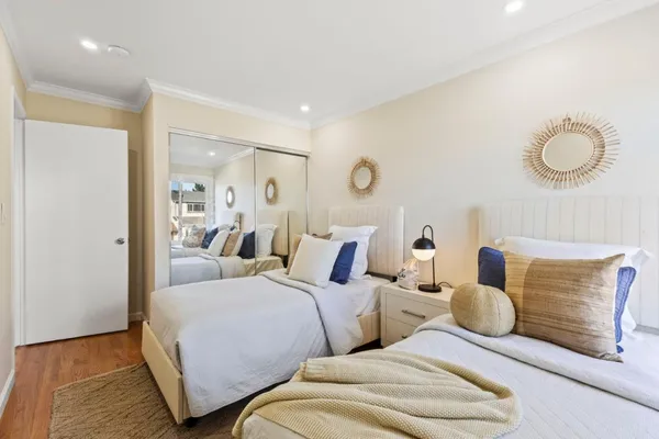 a bedroom with two beds and painted walls