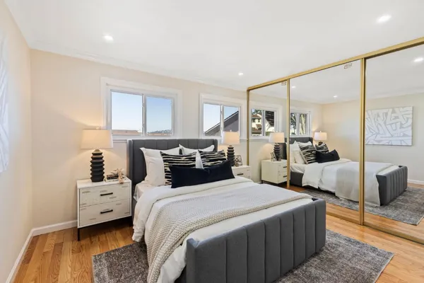 a bedroom with a bed and a couch