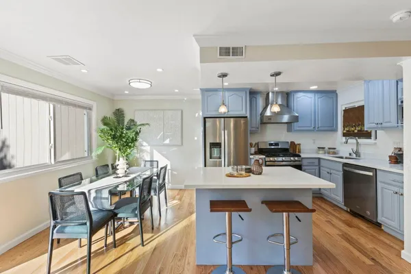 a kitchen with granite countertop white cabinets and stainless steel appliances