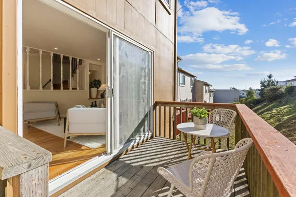 a view of a balcony with couch and wooden floor