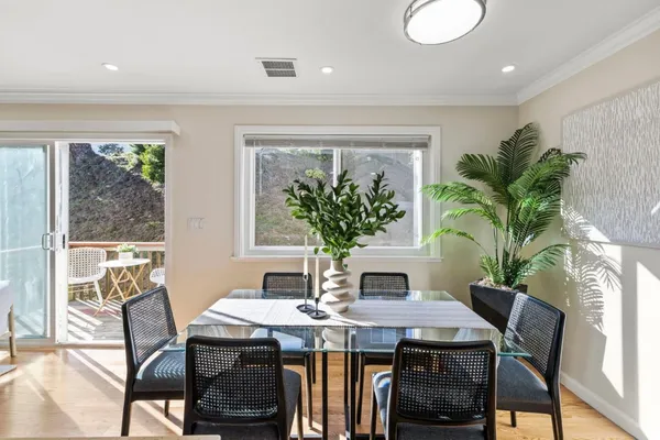 a view of a dining room with furniture window and wooden floor