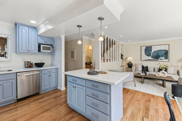 a kitchen with a sink stove and cabinets