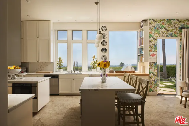 a kitchen with a sink stove and dining table