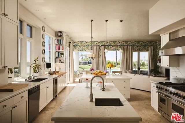 a large white kitchen with a large window