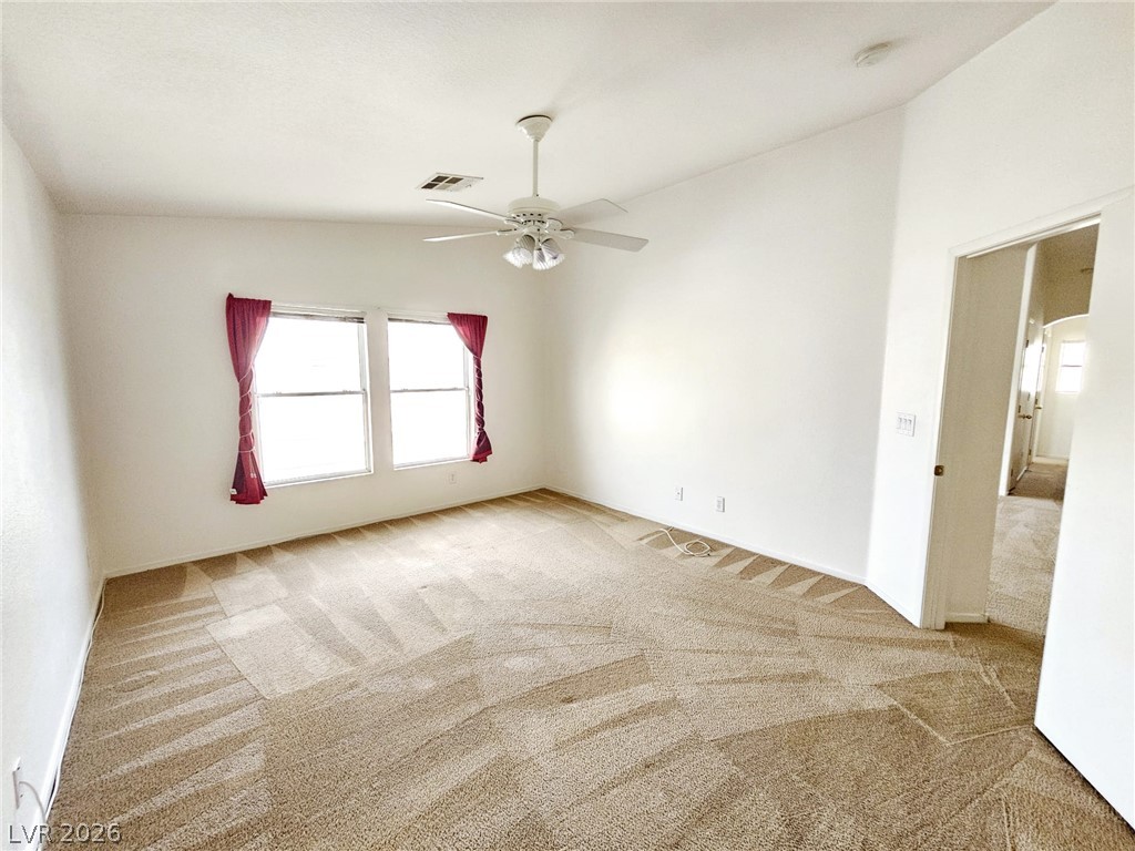 1663 Lefty Garcia Way Henderson, NV 89002 - Photo 4 of 31 Comfortable carpeted bedroom with a ceiling fan, ready for your personal touch.