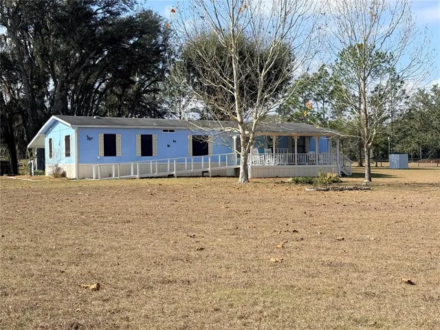 a front view of house with yard and trees