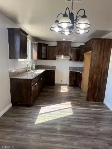 a large kitchen with stainless steel appliances granite countertop a sink stove and refrigerator