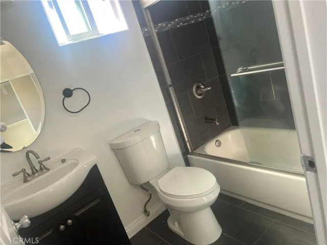 a bathroom with a toilet sink and shower