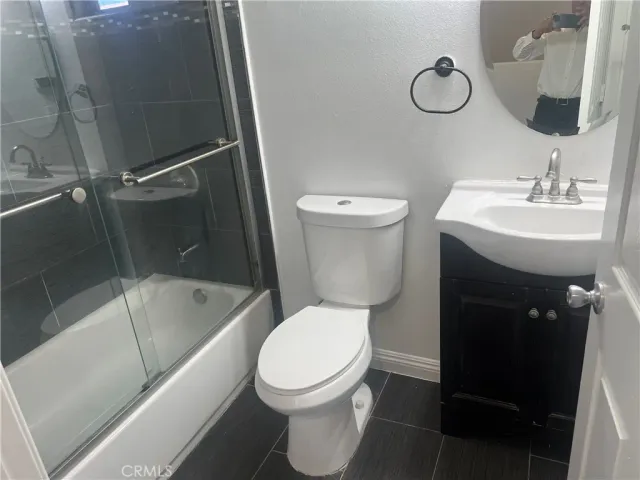 a bathroom with a toilet a sink and bathtub