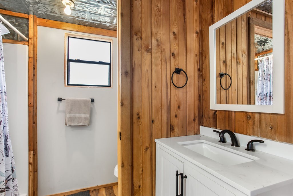 9475 Highway 377 Junction, TX 76849 - Photo 12 of 40 a bathroom with a granite countertop sink a mirror and shower
