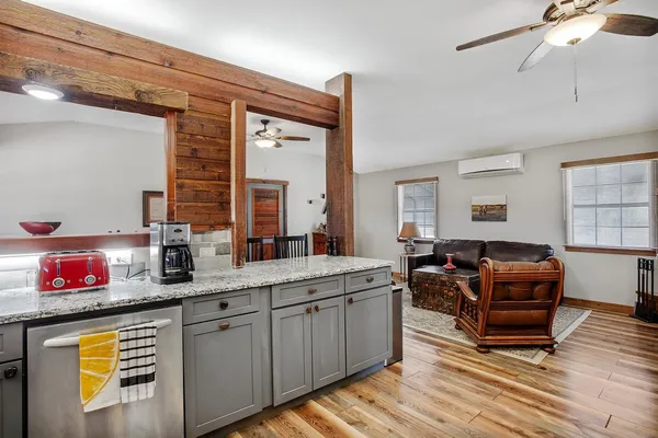 a open kitchen with stainless steel appliances granite countertop a stove and a sink with cabinets