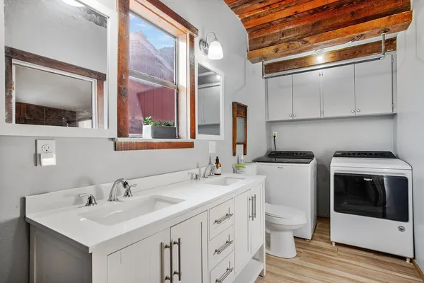 a bathroom with a double vanity sink and mirror