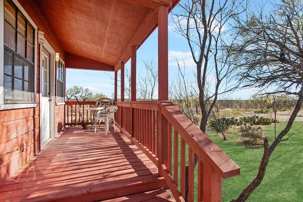 a balcony with view of trees in front of it