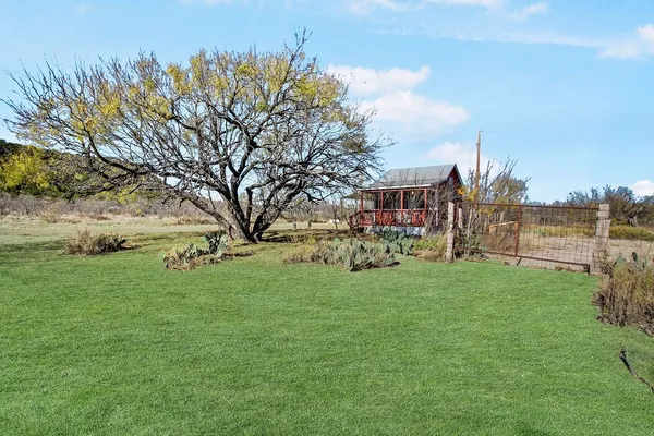 a view of a garden with a building in the background