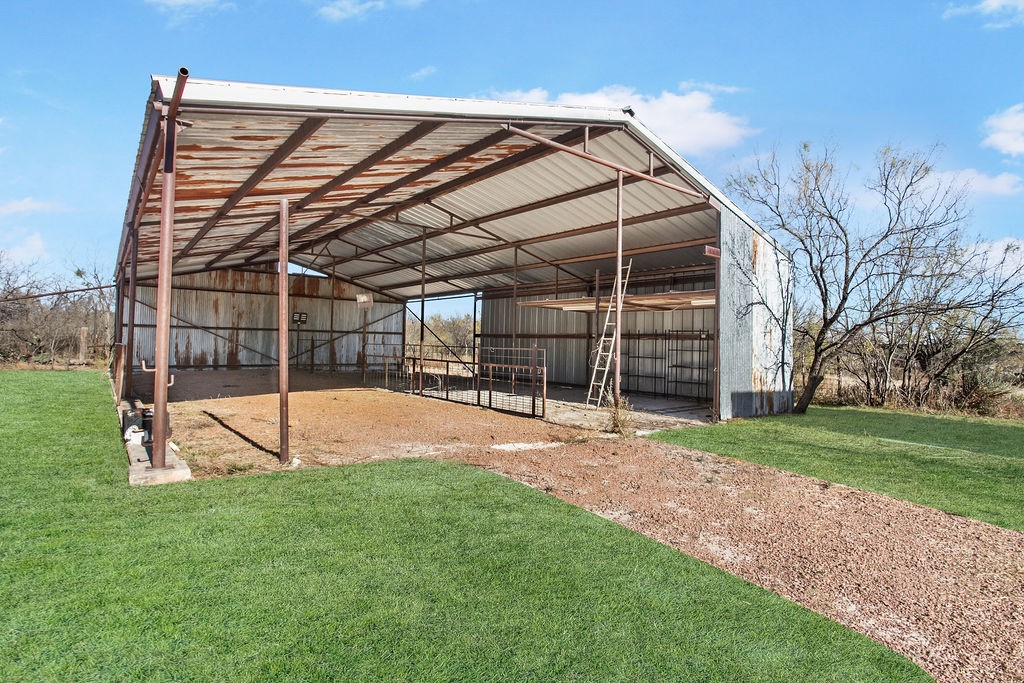 9475 Highway 377 Junction, TX 76849 - Photo 7 of 40 a view of a backyard with table and chairs under an umbrella