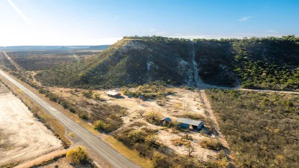a view of a yard with a wooden fence