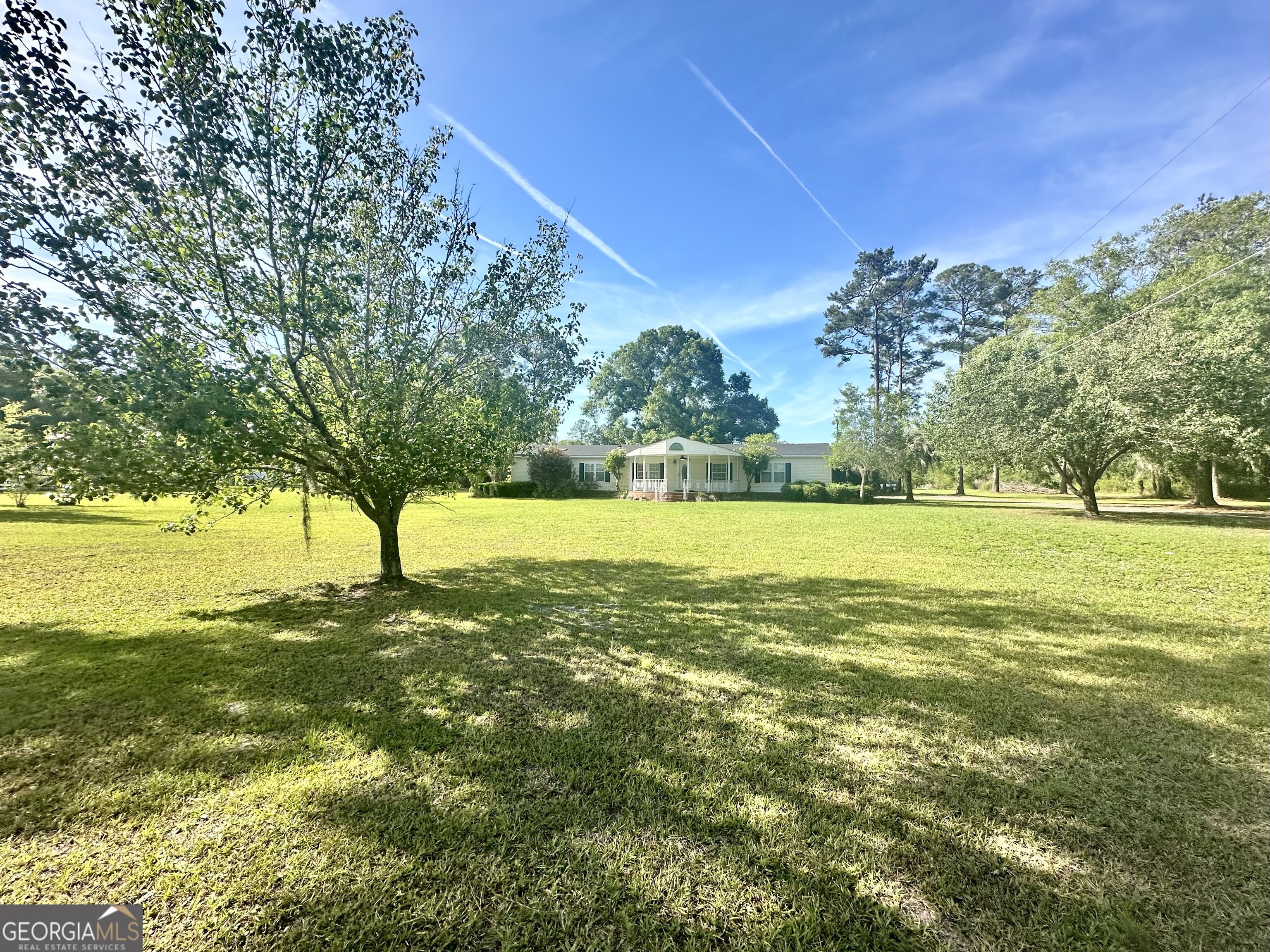 6498 Central Avenue Waycross, GA 31503 - Photo 20 of 20 a view of yard with swimming pool and green space