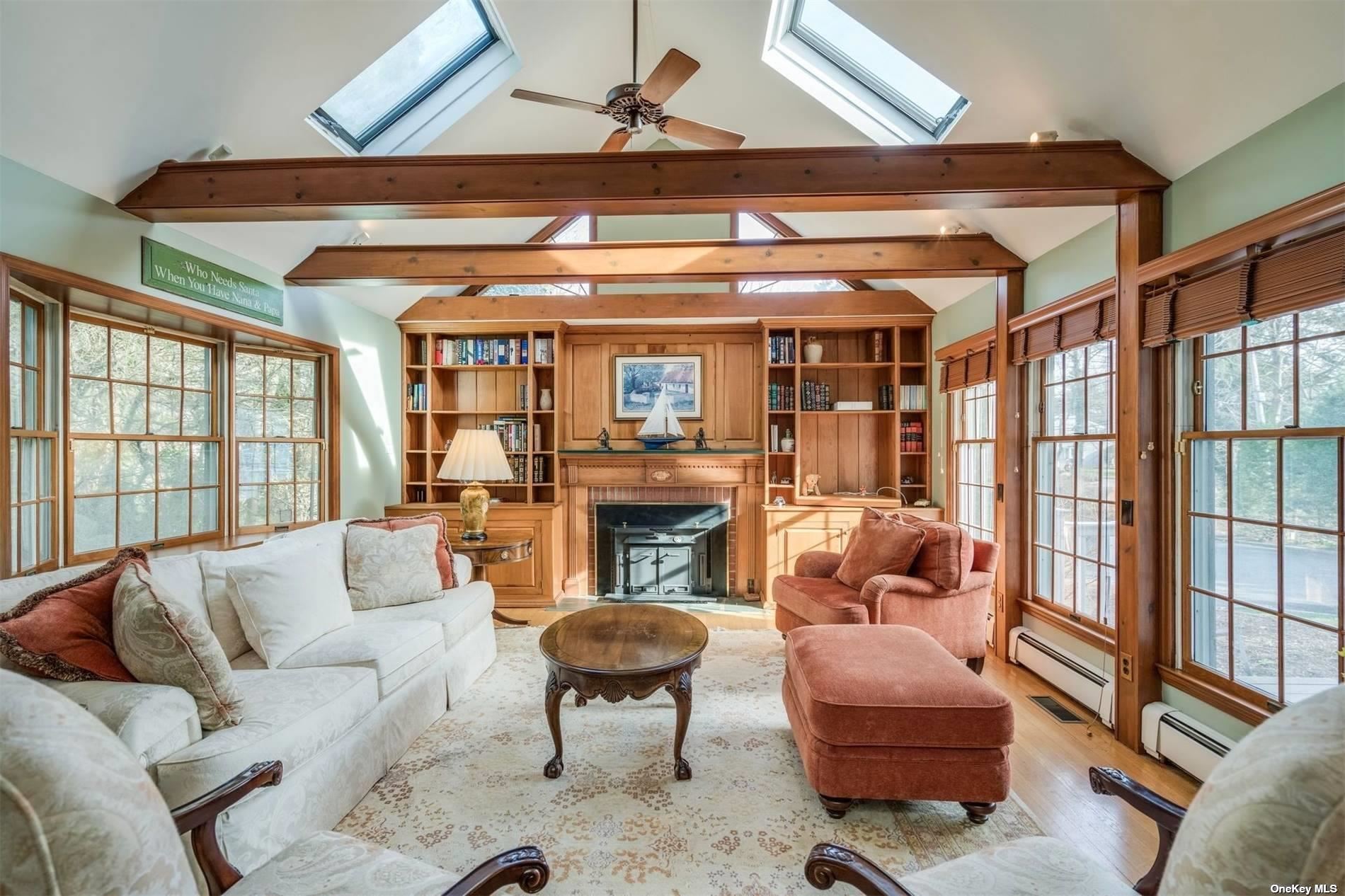 289 West Neck Road Huntington, NY 11743 - Photo 1 of 1 a living room with furniture a fireplace and a floor to ceiling window