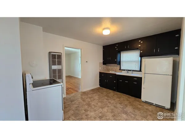 a kitchen with a refrigerator and a stove