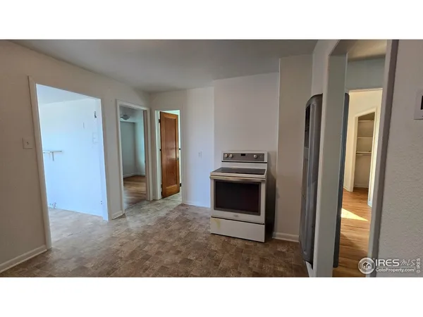 a kitchen with a refrigerator and stove