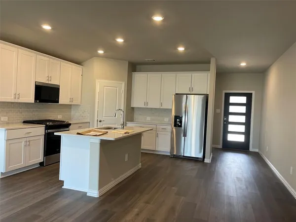 a bathroom with a granite countertop sink a toilet and shower