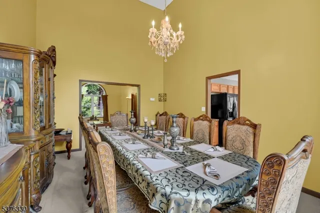 a view of a dining room with furniture and a chandelier