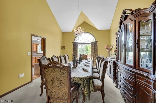 a view of a dining room with furniture and a chandelier