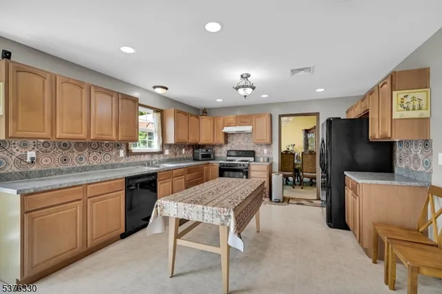 a large kitchen with a table and chairs in it