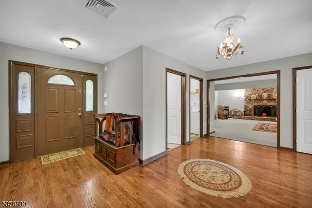 a view of a hallway with furniture and wooden floor