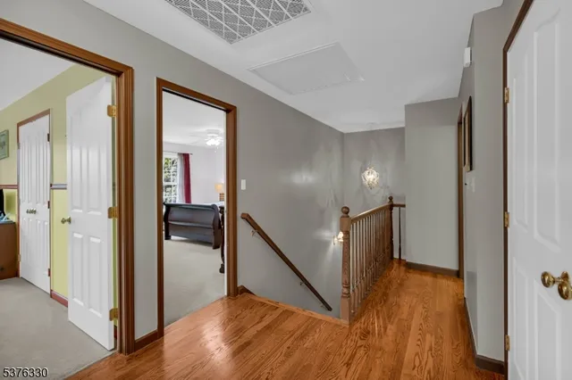 a view of hallway with wooden floor