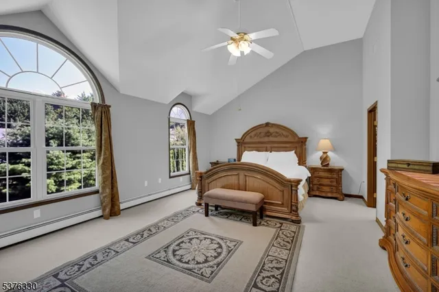 a bedroom with a bed dresser and a window