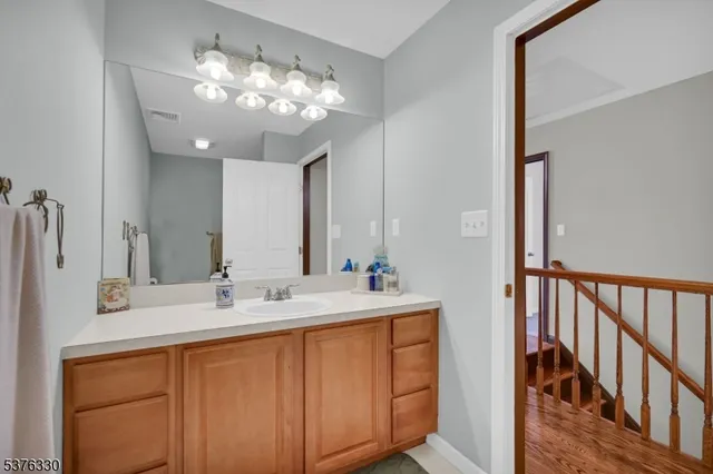 a bathroom with a double vanity sink and a mirror