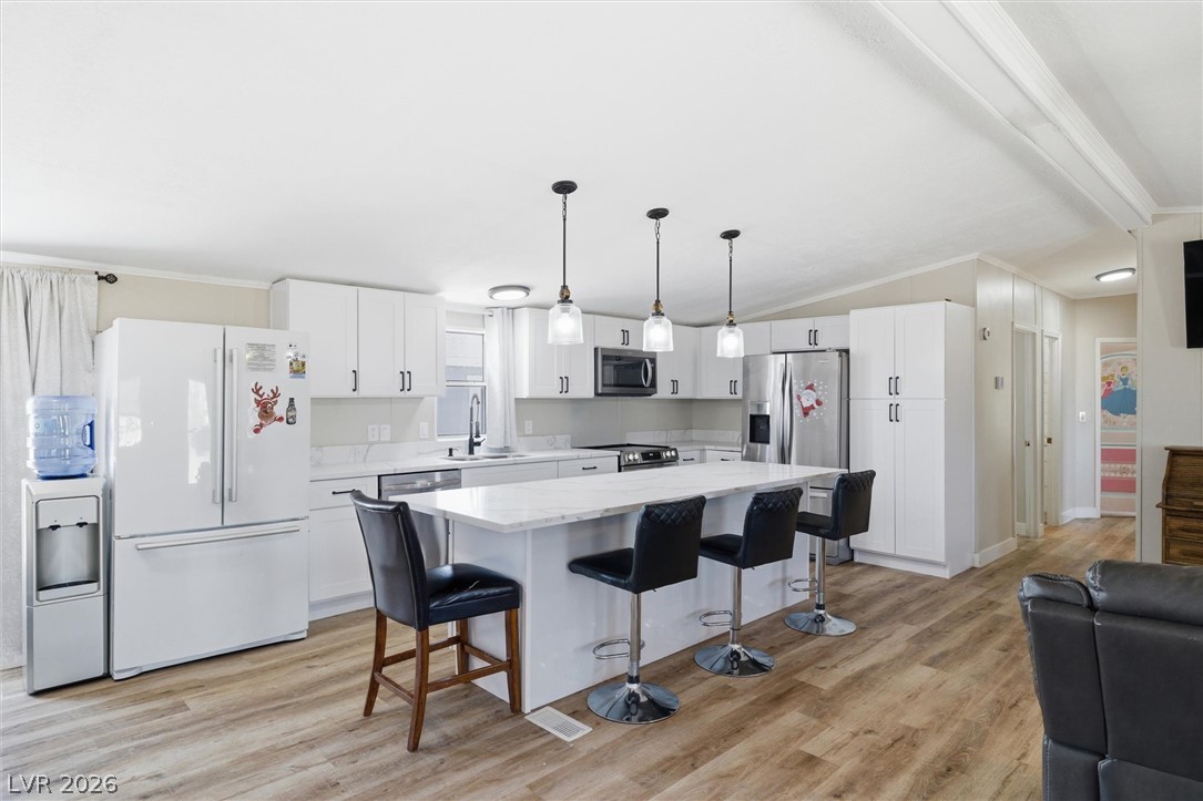 4331 Retread Road Pahrump, NV 89048 - Photo 5 of 31 A well-appointed kitchen features ample counter space, bright cabinetry, and a generously sized island with seating.