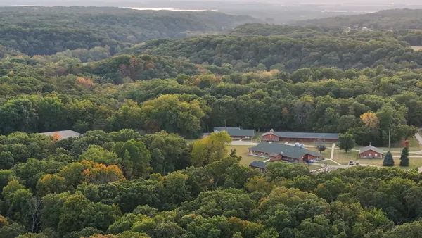 an aerial view of a house with a yard
