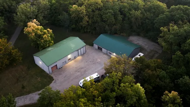 an aerial view of a house with pool fire pit and outdoor seating