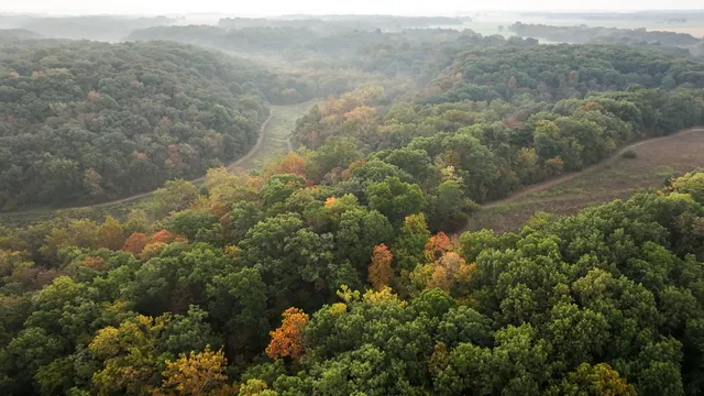 an aerial view of house with yard and mountain view in back