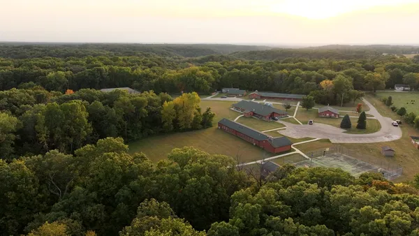 an aerial view of field and trees